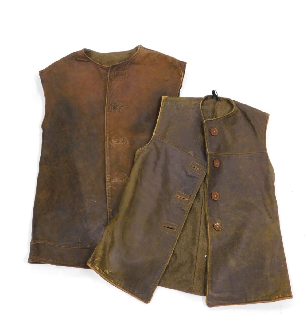 An army issue leather jerkin, size 1, label for M Belmont and Co Limited 1943, and another similar.