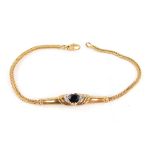 A 9ct gold bracelet, with central dark blue heart cut stone, surrounded by CZ stones, on a bar desig