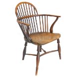 A 19thC yew, ash and elm Windsor chair, with a low hooped back, solid seat and turned legs with crin