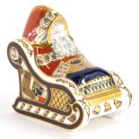 A Royal Crown Derby porcelain paperweight of Santa Claus in a sleigh, with silver coloured stopper,