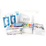 A Nintendo Wii and various accessories and games, to include two Nunchucks, a Wii Sing Robbie Willia