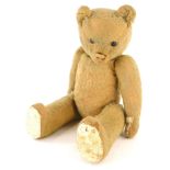 A vintage mohair Teddy bear, with articulated arms and legs and wooden black eyes, 42cm high.