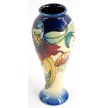 A Moorcroft baluster shaped vase, with tube line decoration of flowers, in red and cream within navy