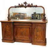 A Victorian figured mahogany sideboard, the raised mirrored back carved with grapes and vines, the i