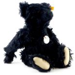 A Steiff Classic black coloured number 32 mohair bear, with original labels, etc., 27cm high seated.