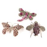 A group of brooches, to include a silver garnet marcasite set dragonfly brooch, and two other paste