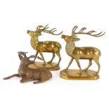 A pair of brass models of stags, each on a canted rectangular base, and a cold painted spelter figur