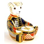 A Royal Crown Derby porcelain paperweight of a drummer bear, with silver coloured stopper, boxed.