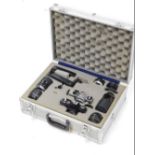 An aluminium camera carrying case, with two cameras and various lenses, to include a Topcon RM300, a