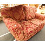 A Kirkdale Furniture two seater sofa, upholstered in red fabric, on brass castors.