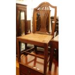 An early 19thC oak side chair, with a pierced vase shaped splat and a woven seat, on plain legs with