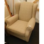 A Next wingback armchair in beige checked upholstered fabric, on turned wooden supports.