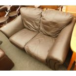 A brown leather two seater sofa.