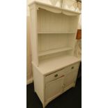 A white painted dresser, the top with pot board, the base with two drawers above panelled doors, 197