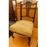 A late 19th/early 20thC walnut nursing chair, with a carved pierced splat, a padded seat on turned l