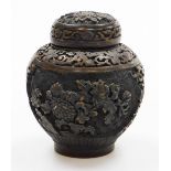 A Chinese composition jar and cover, decorated in high relief with panels of chrysanthemums between