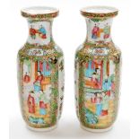 A pair of 19thC Chinese Canton porcelain baluster vases, with panels of figures at court, panels of