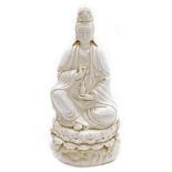 A Chinese blanc de chine figure of Guan Yin seated on a lotus and wave base, impressed mark to the r