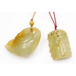 Two carved Chinese jade pendants, one carved as a section of bamboo, 5cm high, another carved as a c