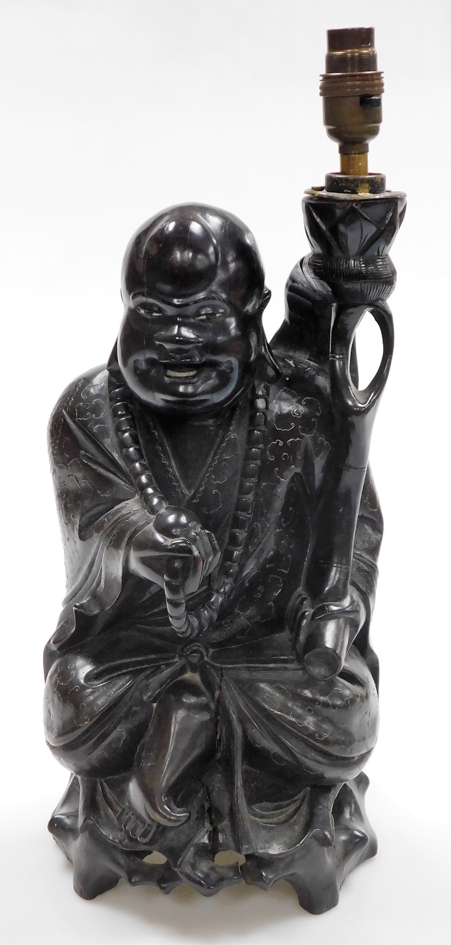 A Chinese teak figure of seated Putai with beads and staff, the body profusely inlaid with silver wi