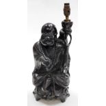 A Chinese teak figure of seated Putai with beads and staff, the body profusely inlaid with silver wi