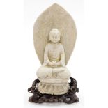 A Chinese carved limestone figure of Buddha seated on a lotus base, holding a cup, the mandala with