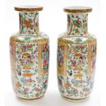 A pair of 19thC Chinese Canton porcelain baluster vases, with scenes of figures at court within a ke