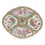 A 19thC Chinese Canton porcelain oval dish, decorated with opposing panels of court scenes and flora