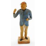 A 19thC Chinese terracotta figure of a standing male, with one arm raised, wearing a blue tunic and