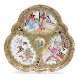 A 19thC Chinese Canton porcelain trefoil dish, decorated with three panels of court scenes and flora