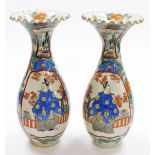 A pair of Japanese porcelain ovoid vases, with frill necks, decorated with enamelled panels of stand