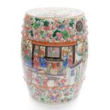 A Chinese porcelain garden seat, of barrel shape profusely decorated with court scenes on a floral a