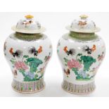 A pair of Chinese porcelain baluster vases and domed covers, decorated with cockerels and peonies be