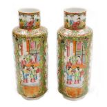 A pair of Chinese Canton vases, each with panels of figures, birds and flowers on a gilt and green f