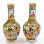 A pair of 19thC Chinese Canton porcelain bottle vases, with panels of figures at court, birds and bu