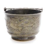 A Japanese bronze brazier with swing handle, low relief decoration of dragons among clouds, 30cm hig