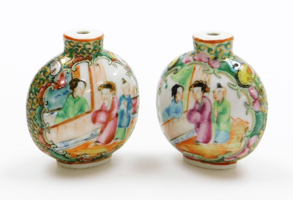 A pair of Canton snuff bottles, each decorated with figures, birds and flowers, 6cm high. (AF)