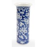 A Chinese porcelain cylinder vase, decorated in blue and white with prunus branches, four character