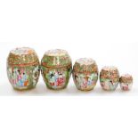A graduated set of 19thC Chinese Canton porcelain jars and covers, decorated with panels of figures,