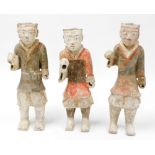 A set of three Western Tang Dynasty painted pottery figures of warriors, each figure standing in hol