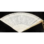 A Canton Chinese ivory pierced fan, with fine detailing, bearing the central shield shaped cartouche