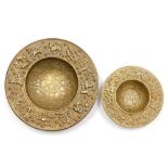 Two hammered brass bowls, each with zodiac borders, 21.5cm and 14.5cm wide. (2)