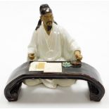 A Chinese terracotta and white glazed "mudman" figure of a scholar seated at table, the gentleman AF