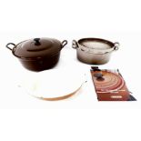 A Le Creuset brown lidded round casserole dish No 32, Le Creuset grey oval roaster doufeu No 27, tog