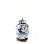 A Chinese porcelain lamp base, decorated with flowers and birds, and with a beige silk shade, 80cm h