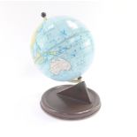 A Chad Valley mid century tin plate terrestrial globe, raised on a brown base, 27cm high.