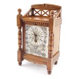 A French Aesthetic late 19thC oak cased mantel clock, rectangular ceramic dial painted with an urn o