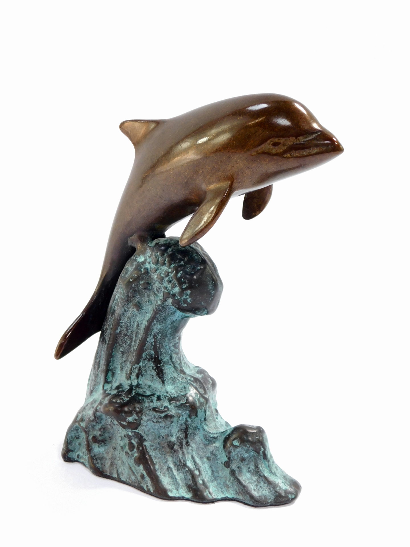 A bronze figure of a dolphin riding the wave, 15cm high.