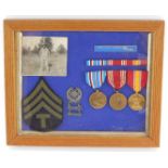 American medals and badges, framed.