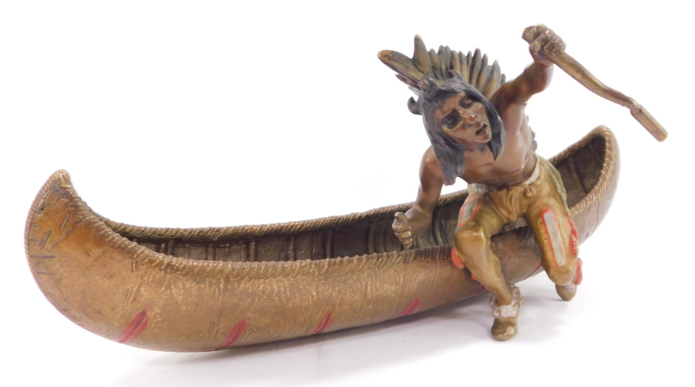 A Franz Bergman style cold painted bronze model of a Native American Indian, seated in a canoe, impr